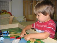 James Davern plays with his Thomas the Tank Engine toys.