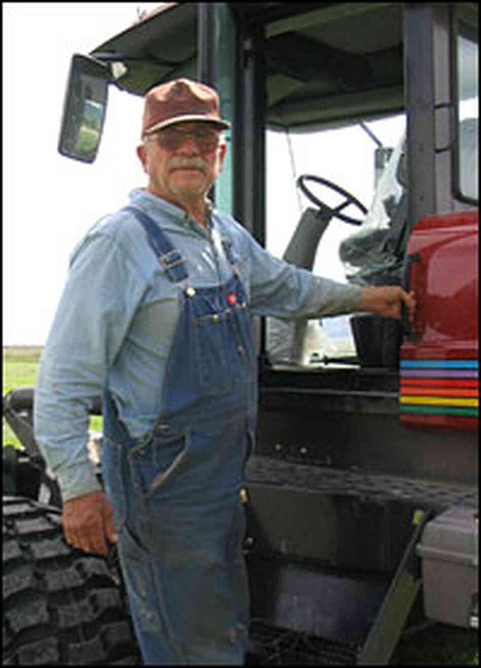 Cecil Garland climbs into his swather.