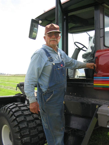 Cecil Garland climbs into his swather.