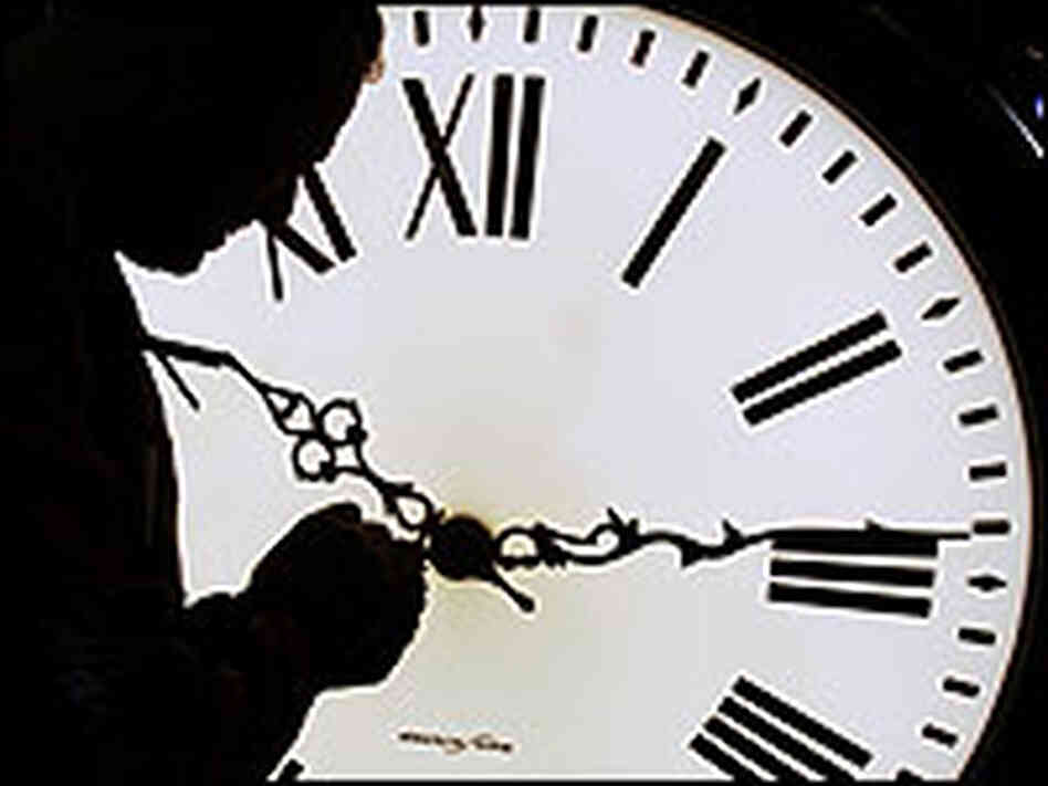A worker adjusts a clock's hand on a Seth Thomas post clock at the Electric Time Company in Mass. A worker adjusts a clock's hand on a Seth Thomas post clock at the Electric Time Company in Mass.