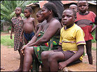 Monday Mweke, age 9, seen here with his mother, Monday Mweke, age 9, seen here with his mother,
