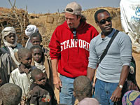 John Prendergast and Don Cheadle visit a refugee camp on the Darfur-Eastern Chad border.