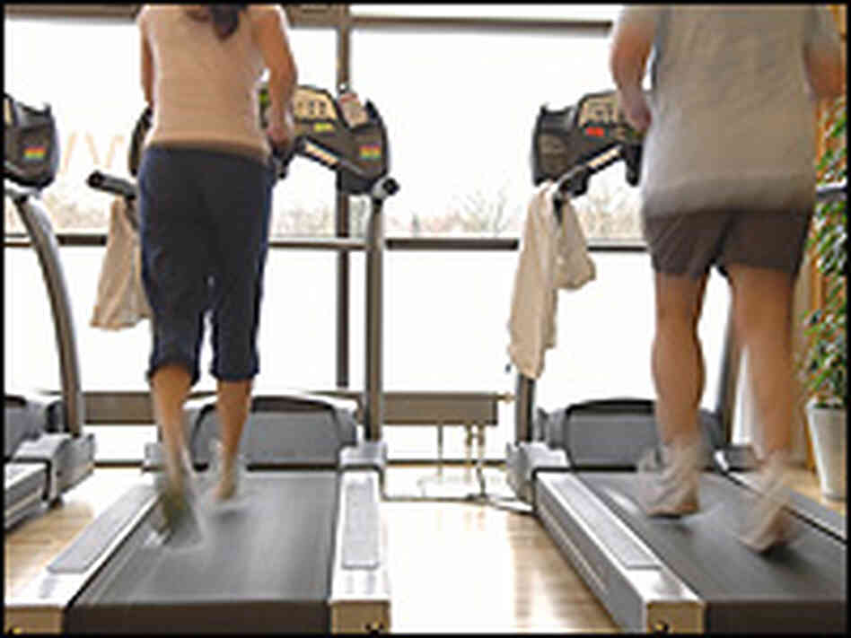A couple of people on treadmills A couple of people on treadmills