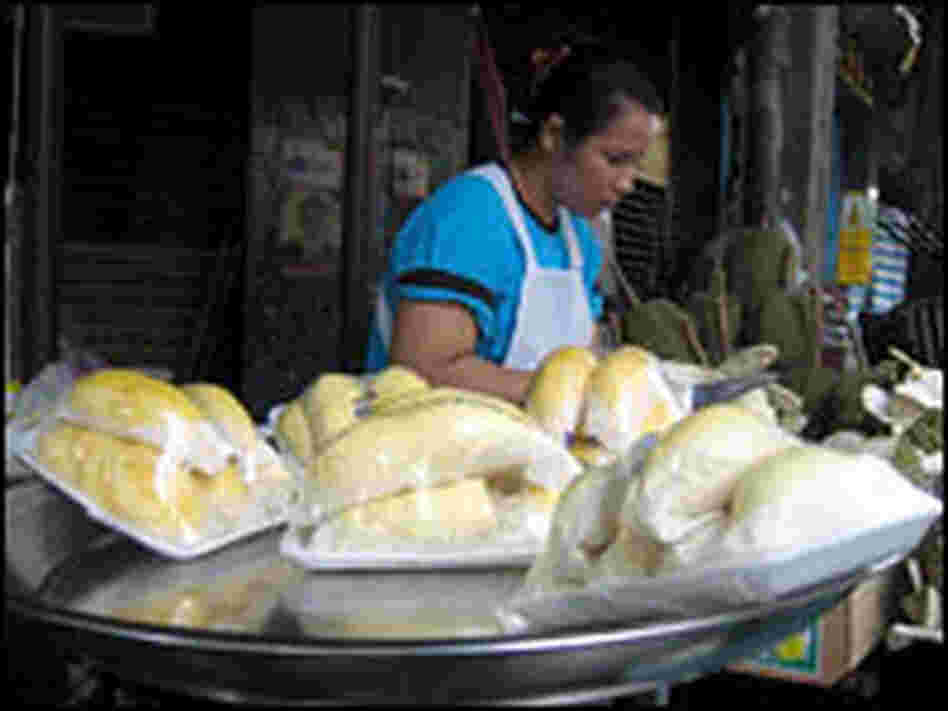 Fresh durians wrapped in pieces are for sale at a street stall in Bangkok.