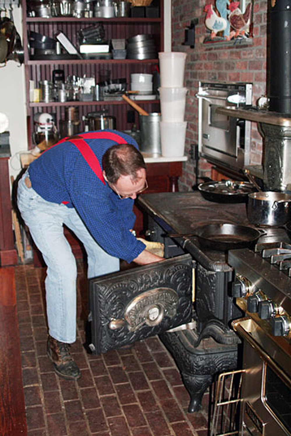 Kimball bakes a pie in the reconditioned Olds and Whipple stove in his farmhouse kitchen.