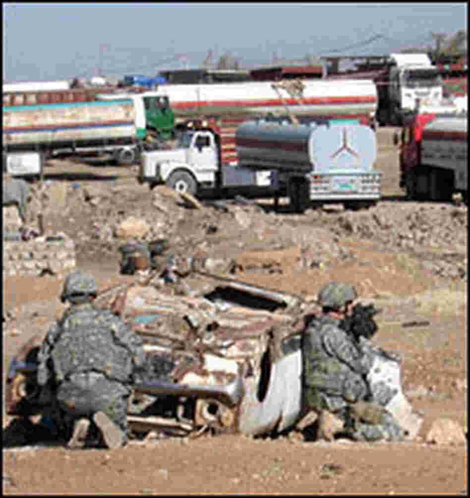 U.S. soldiers with the 2-7 Cavalry take up positions during a raid in southwestern Mosul.