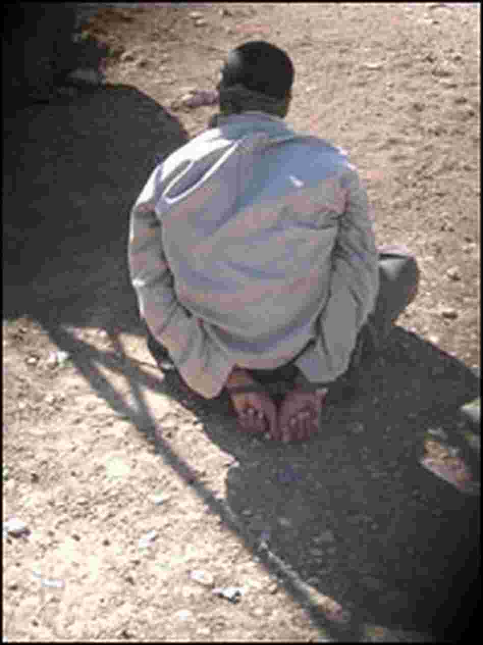 A suspected insurgent is blindfolded and handcuffed.