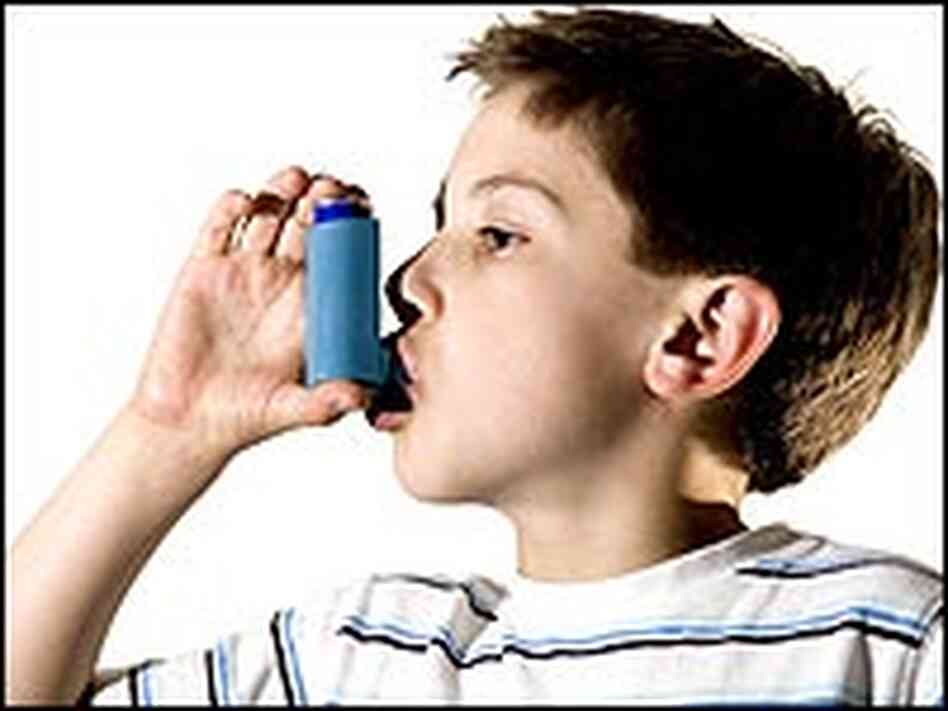 A boy using an asthma medicine inhaler. A boy using an asthma medicine inhaler.