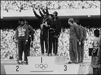 Americans give black power sign to crowd after receiving gold medal at Olympics in Cuba.