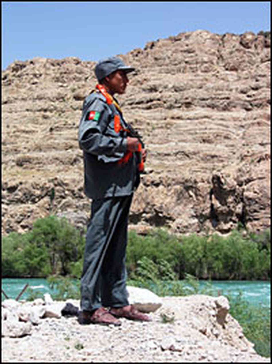 An Afghan police officer guards the Kajaki dam compound.
