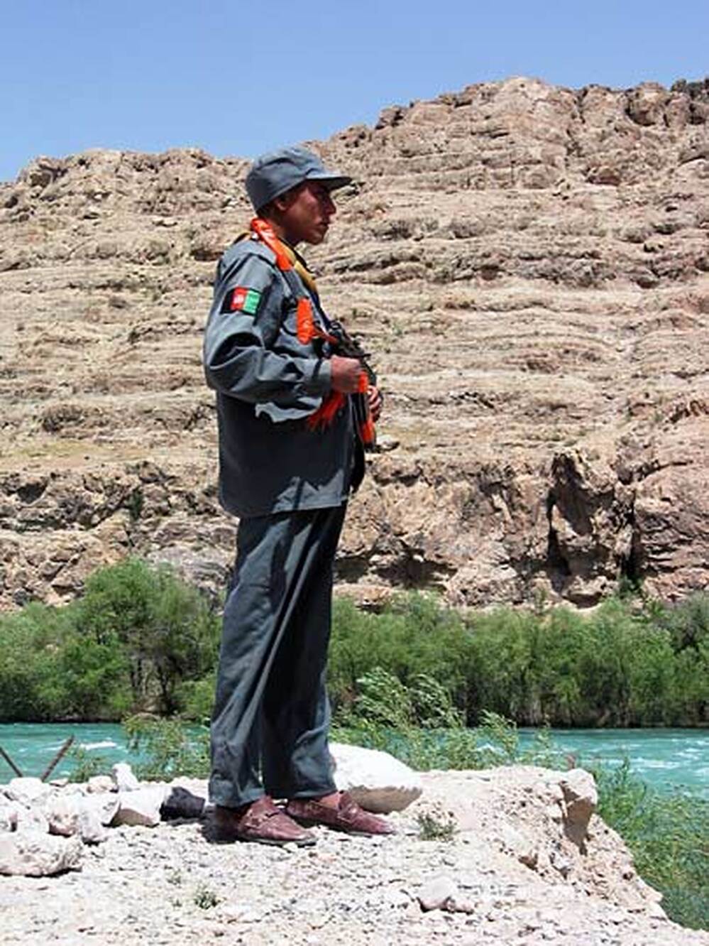 An Afghan police officer guards the Kajaki dam compound.