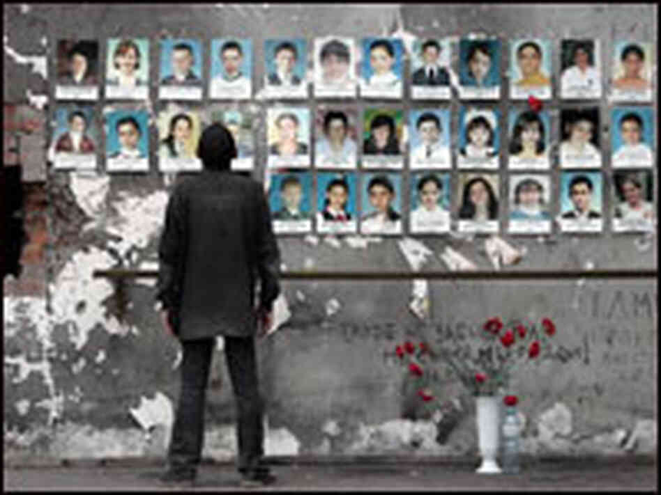 A man looks at pictures of children killed in the Beslan school hostage situation.