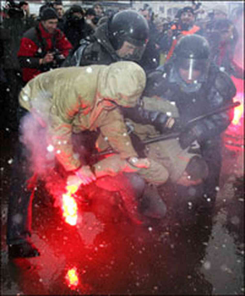 Russian riot police detain an opposition activist during a protest in March.