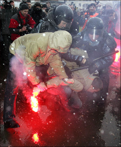 Russian riot police detain an opposition activist during a protest in March.