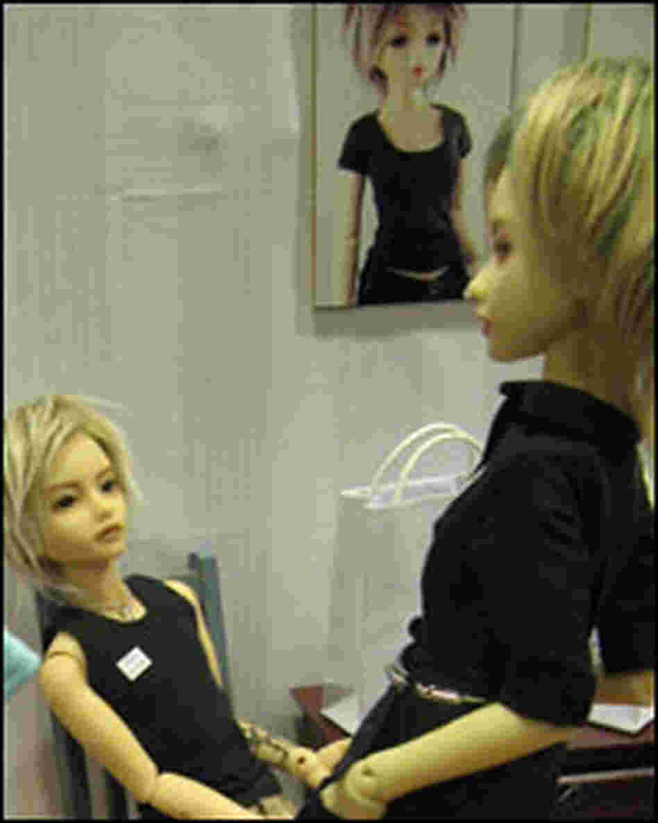 A vendor display at Dollectable features BJDs trying on clothes.