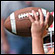 A hand holds a football. Credit: iStockphoto.com