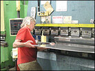Alex Monell bends metal at a sheet metal shop. Alex Monell bends metal at a sheet metal shop.