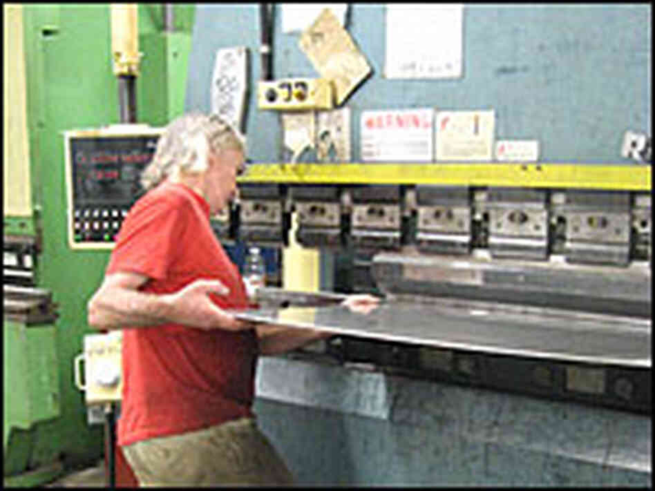 Alex Monell bends metal at a sheet metal shop.