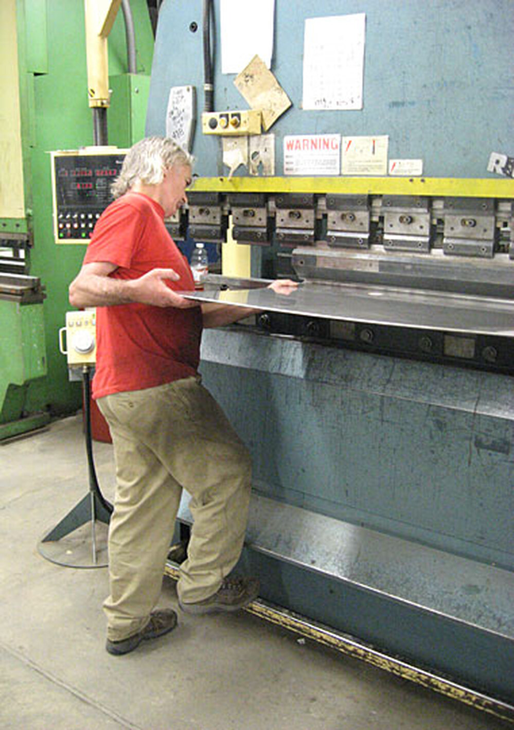 Alex Monell bends metal at a sheet metal shop.