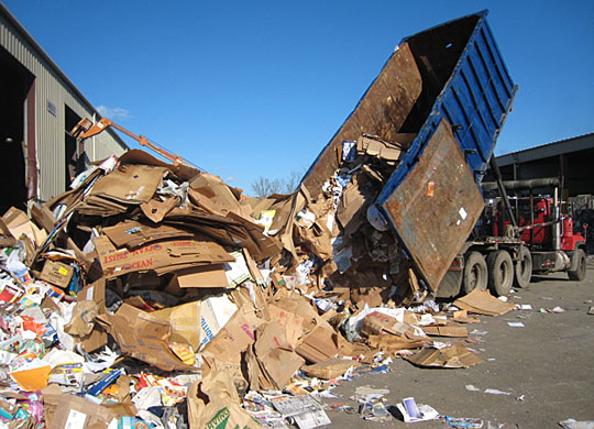 A truck dumps recycled paper at Willimantic Waste Paper Co.