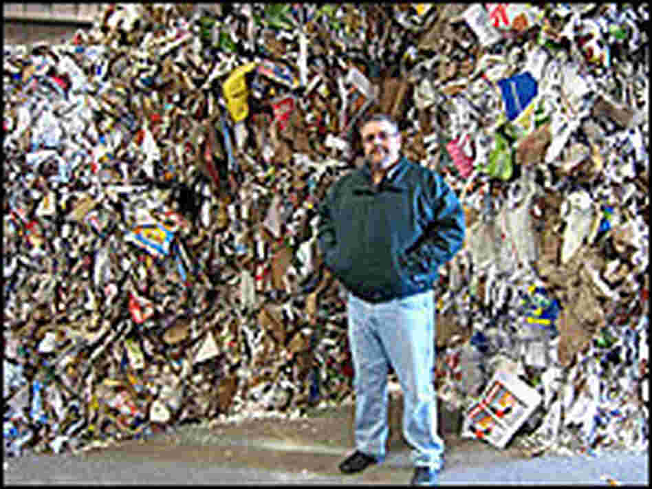 Willimantic's Tim DeVivo stands in front of a pile of mixed paper he can't sell.