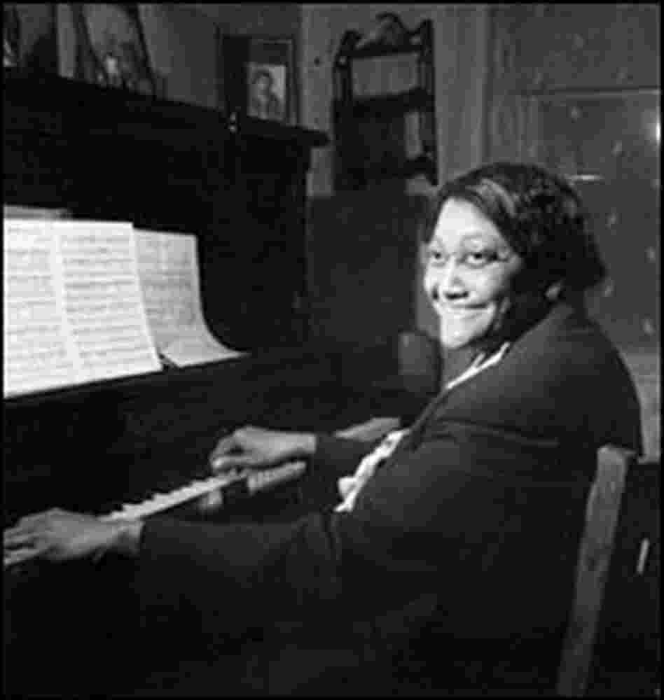 Vietta Garr sits at a piano.