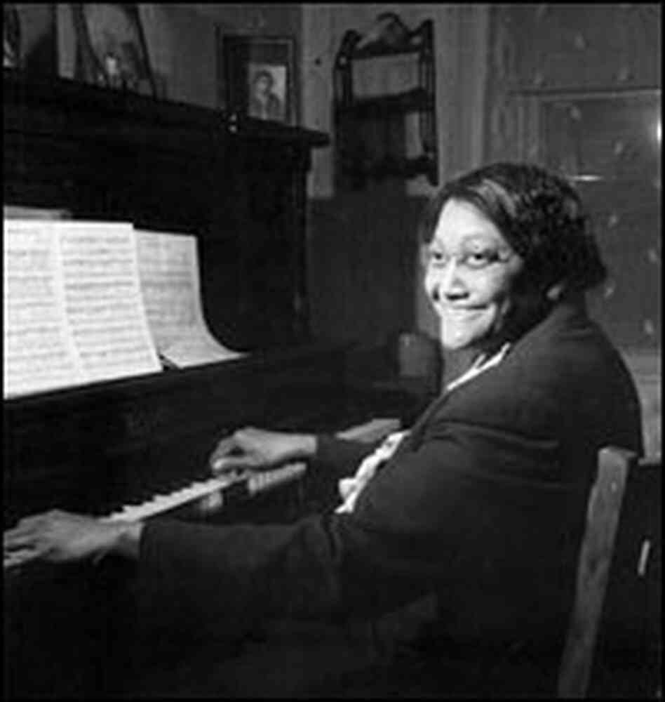 Vietta Garr sits at a piano.