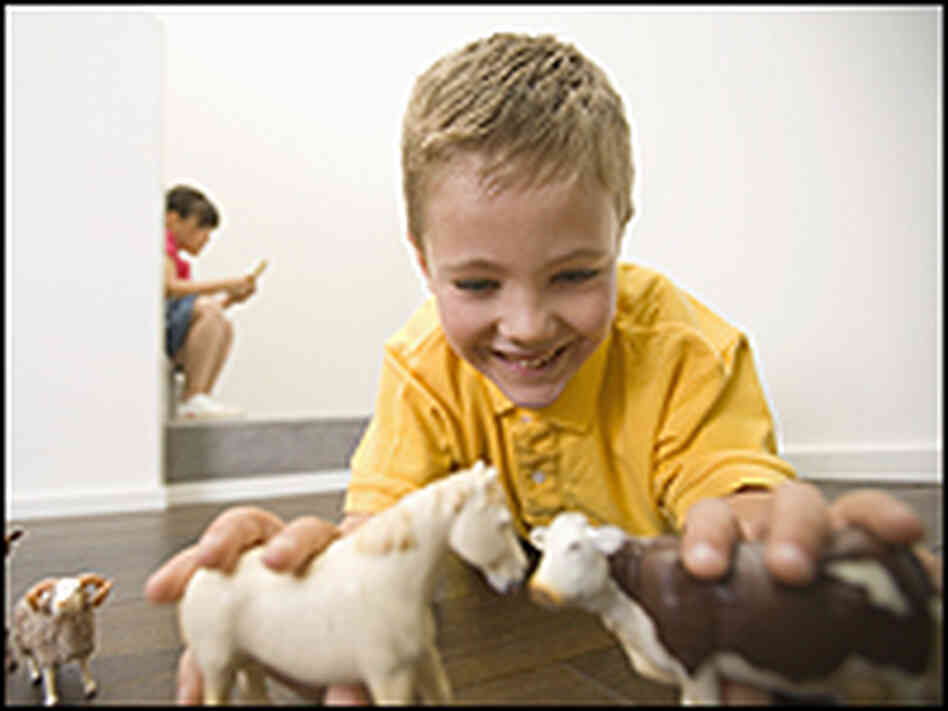 Boy playing with animal figurines Boy playing with animal figurines