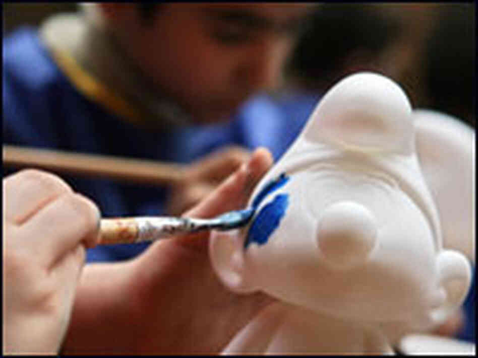 Children paint Smurf figurines in Berlin.