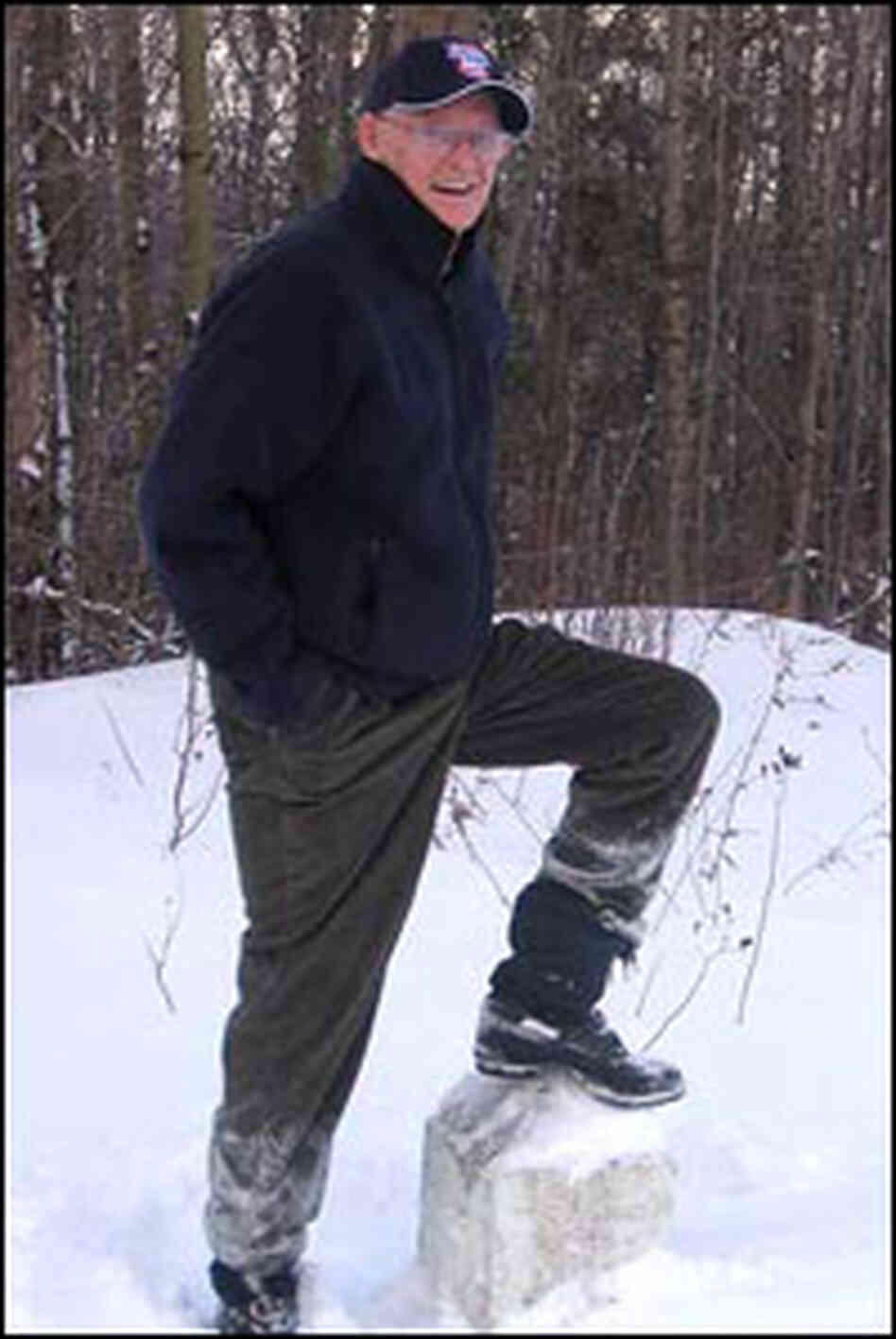 Davis stands hear a marker that indicates the border.