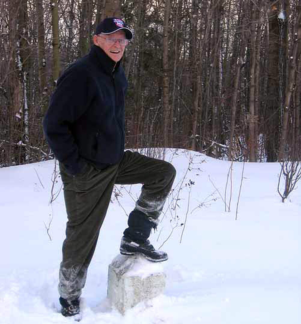 Davis stands hear a marker that indicates the border.