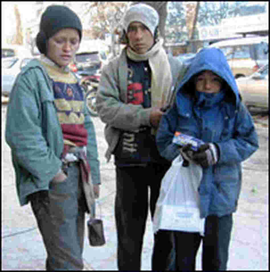 Ruzadin, 11, stands with fellow street children in Kabul.