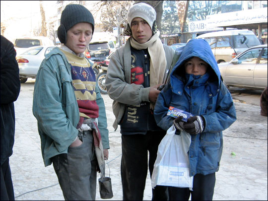 Ruzadin, 11, stands with fellow street children in Kabul.