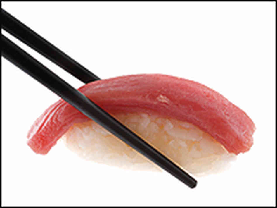 Chopsticks and tuna sushi. Chopsticks and tuna sushi.
