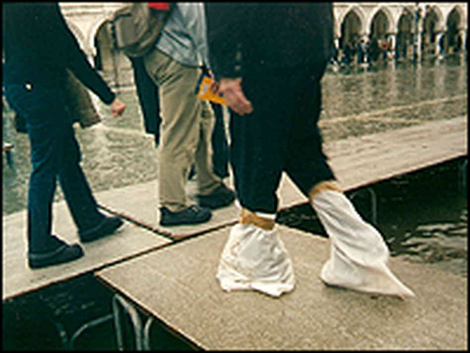 Venetians walk on raised walkways.