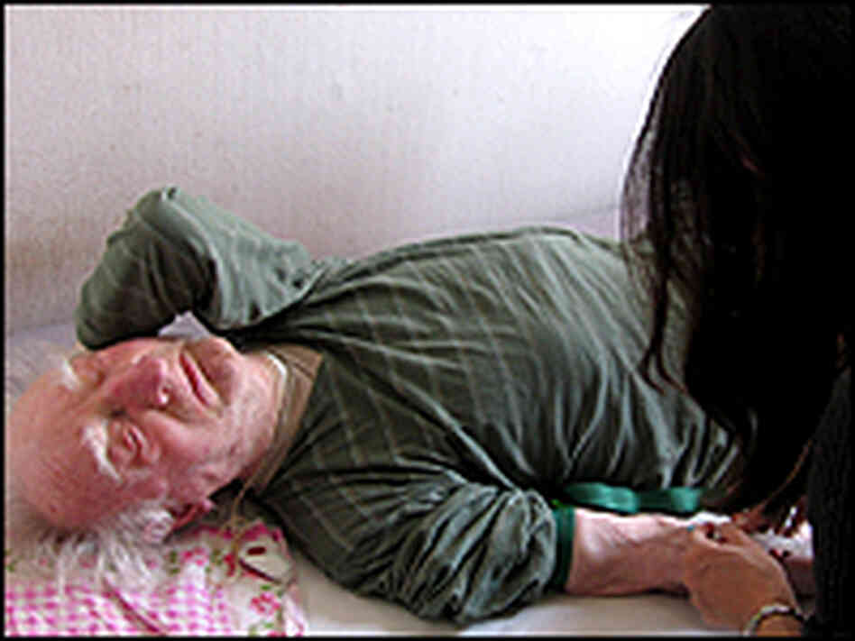 Paques injects an elderly patient with medicine. Paques injects an elderly patient with medicine.