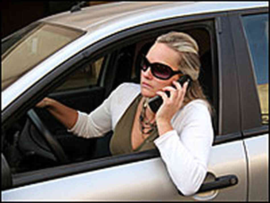 A female driver talking on her cell phone.