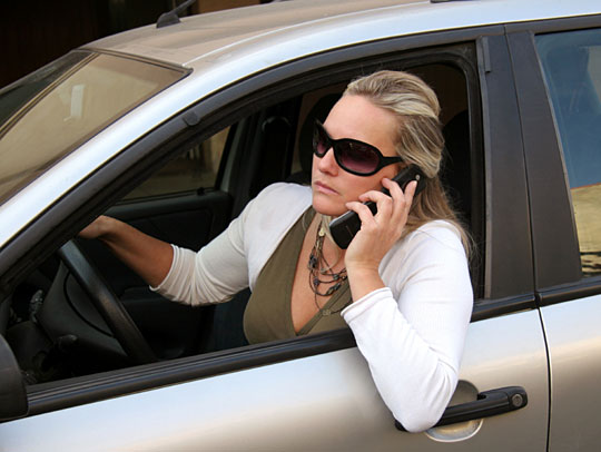 A female driver talking on her cell phone.