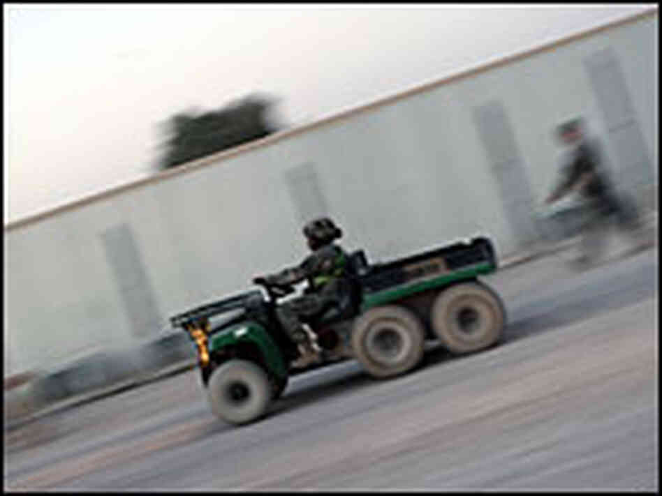 U.S. Soldier driving a gator on the base