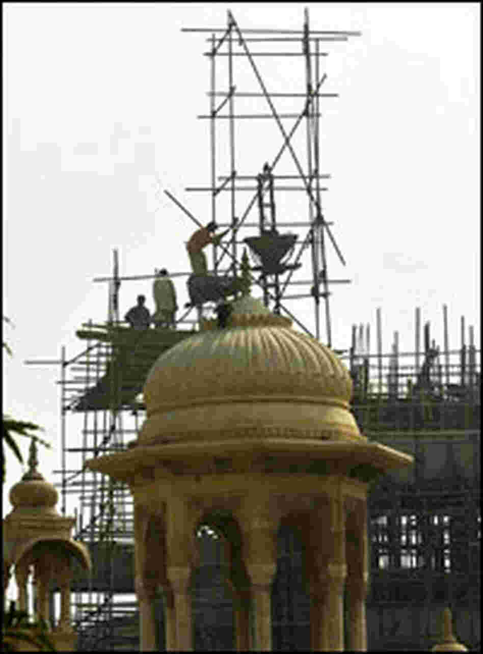 Pakistani laborers work a multistory building in Karachi, Pakistan