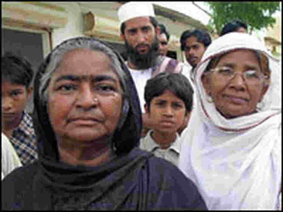 Sabra Khadun supervises workers digging a water line.