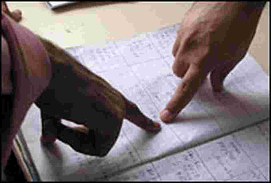 Workers point to log book entries at a command post in Karachi lists recent ambulance calls.