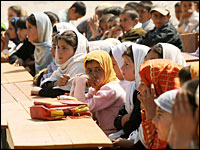 Afghan students listen during an opening ceremony at a school in Kabul in March. Authorities are struggling to ease overcrowding in local schools — one of the many development challenges Afghanistan faces.