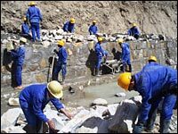 Local workers build a retaining wall in Kunar province — another PRT project.