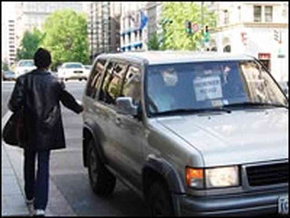 A Virginia-bound commuter catches a ride in downtown Washington, D.C.