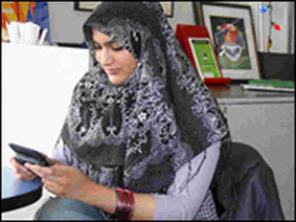 Mediha Sandhu texts in an Internet cafe.