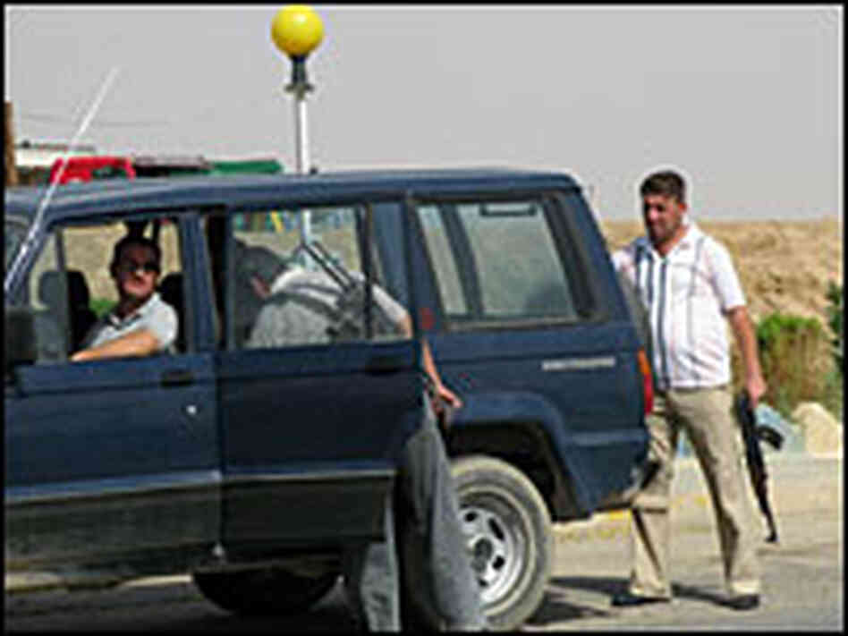 Christian forces with the Qaraqosh Protection Committee searching a vehicle