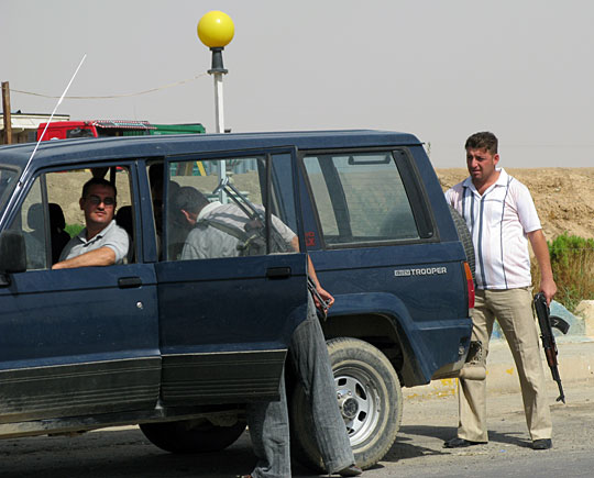 Christian forces with the Qaraqosh Protection Committee searching a vehicle