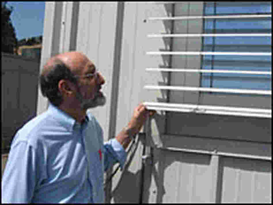 Steve Selkowitz examines the shutters at the Window Lab at The Lawrence Berkley National Labratory.