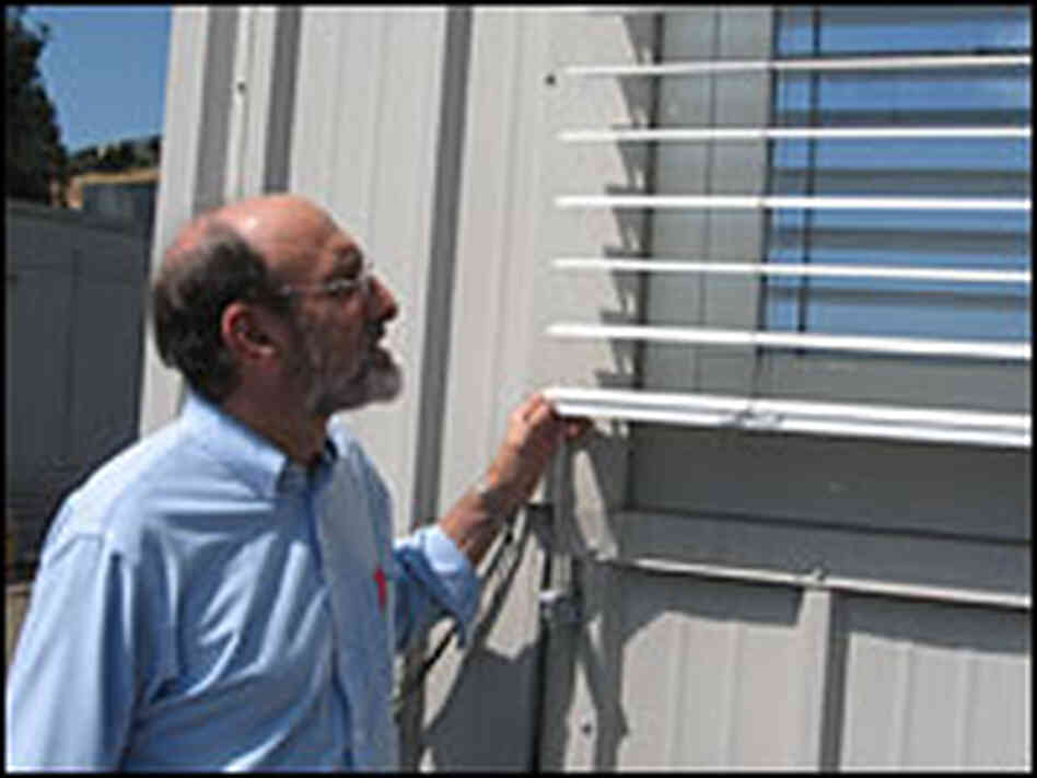 Steve Selkowitz examines the shutters at the Window Lab at The Lawrence Berkley National Labratory.